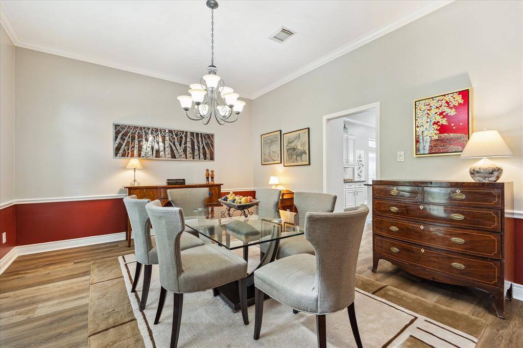 The formal dining room is to our left, as we enter. You can see the kitchen beyond. It has a chair rail and an accent wall.