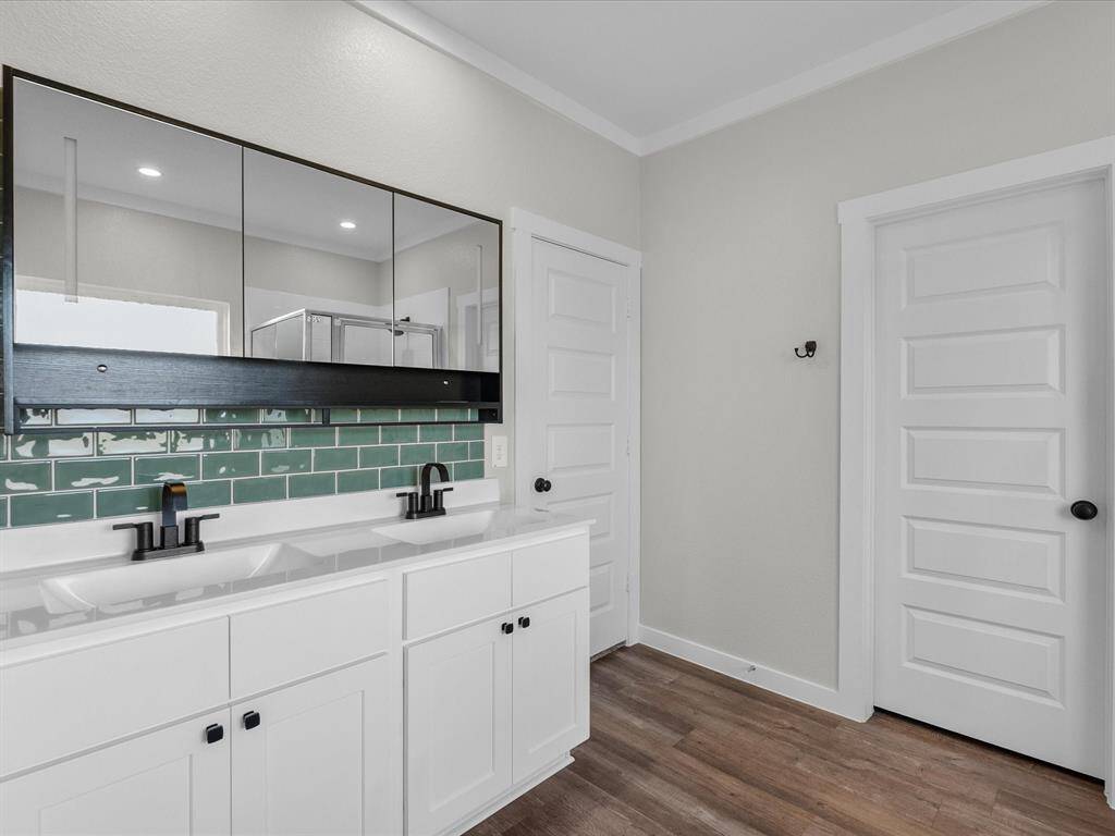 Primary bath features double sinks, soaking tub, walk-in shower and a walk-in closet