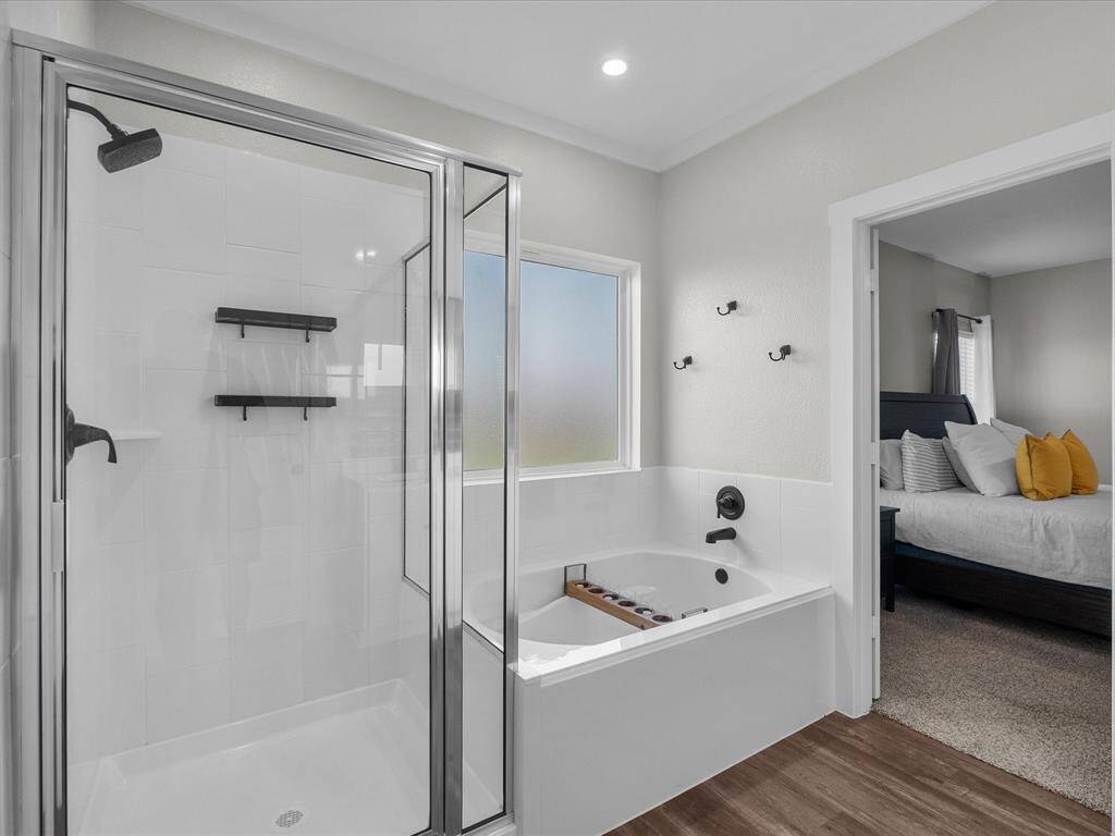 Primary bath features double sinks, soaking tub, walk-in shower and a walk-in closet