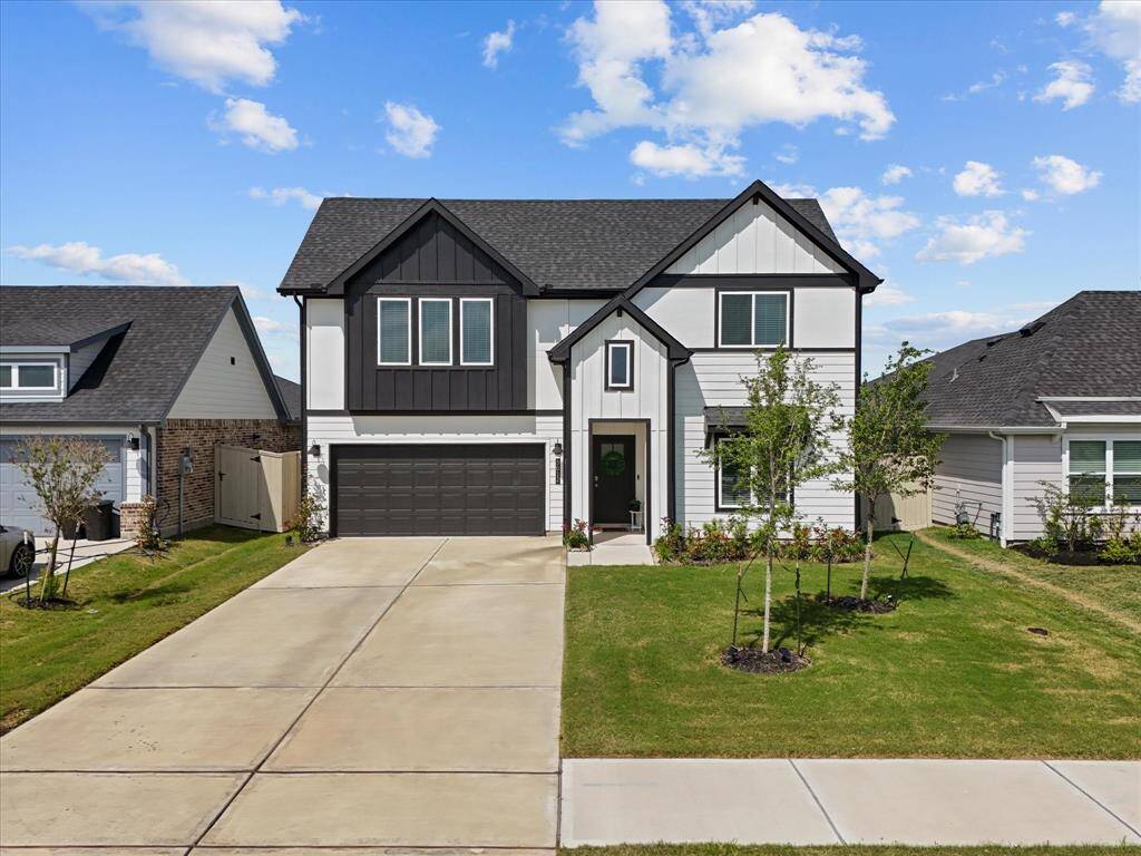 Black and white two-story farm house stunner with no rear neighbors