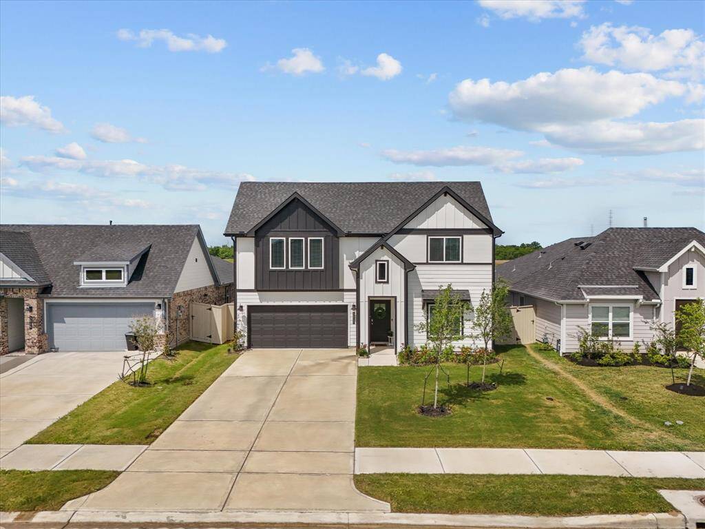 Black and white two-story farm house stunner with no rear neighbors
