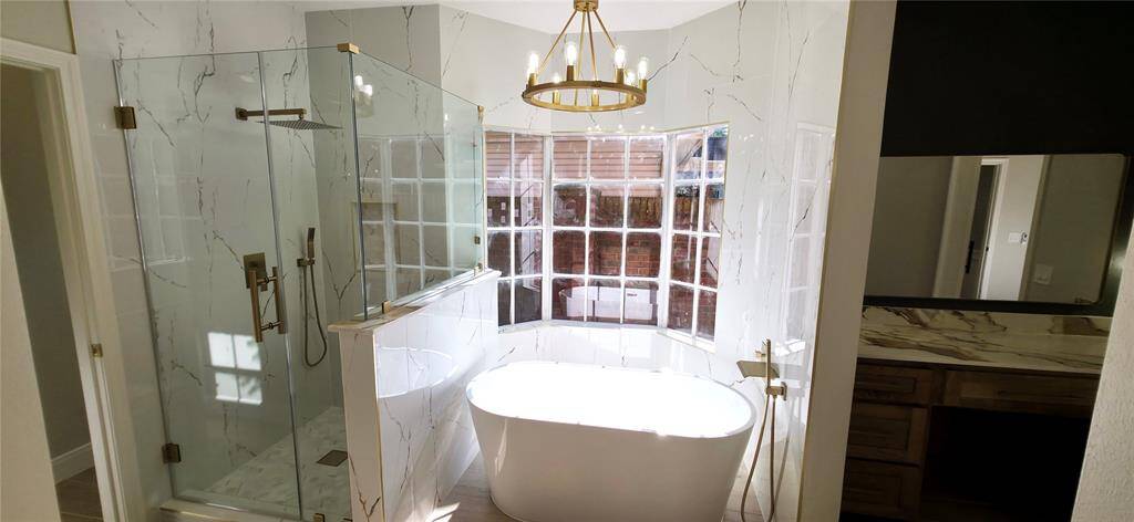 Primary bathroom with large shower and stand alone tub