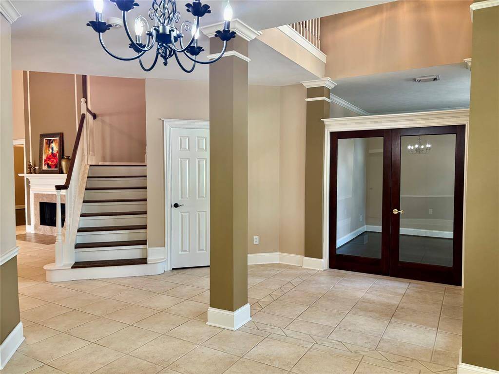 Prestigious study with hardwood floors and double French doors.