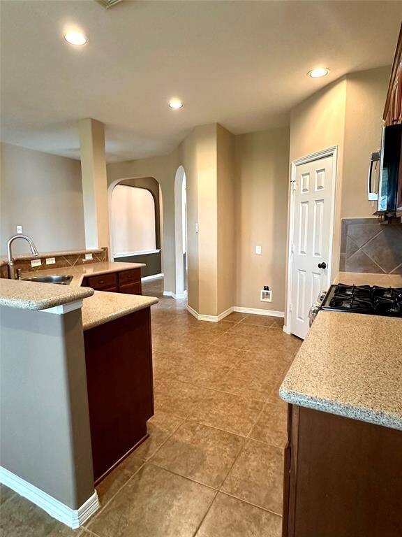 Open kitchen area with stainless appliances allows for easy flow of traffic, perfect for those busy mornings!
