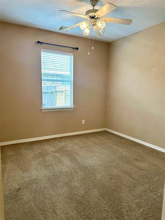 A different view of the 3rd bedroom with ceiling fan