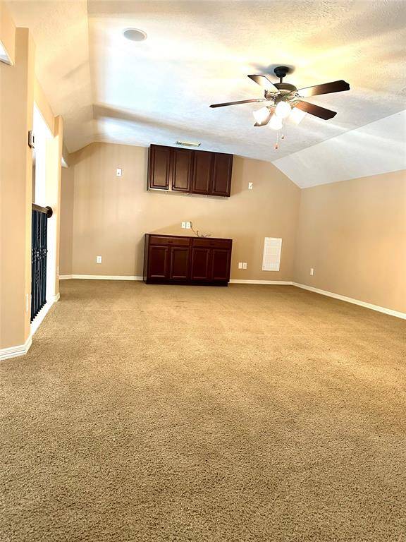 Bonus room upstairs with ceiling fan and built-in cabinets. Perfect for a play room, poker area, office space, and many other possibilities!