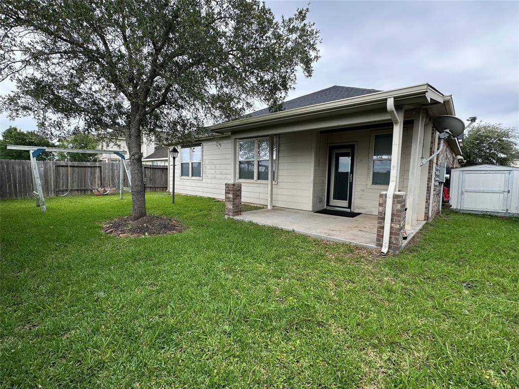 Backyard comes with covered patio area and a Tuff shed for additional storage