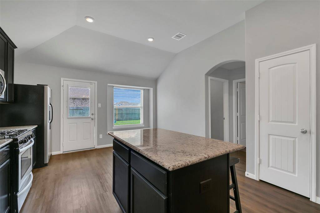 Additional storage provided by the island while the door to the Right reveals the pantry.