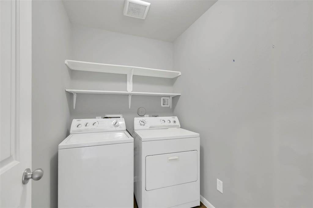 Laundry room, which is conveniently located before accessing the primary bedroom.