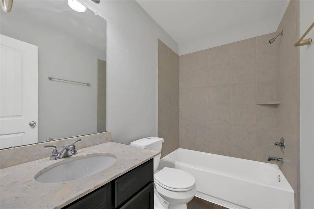 Within steps of each secondary bedroom is the hall bathroom. This bathroom offers a quartz vanity with under-mount sink, as well as a tub/shower combination with tiled surround.