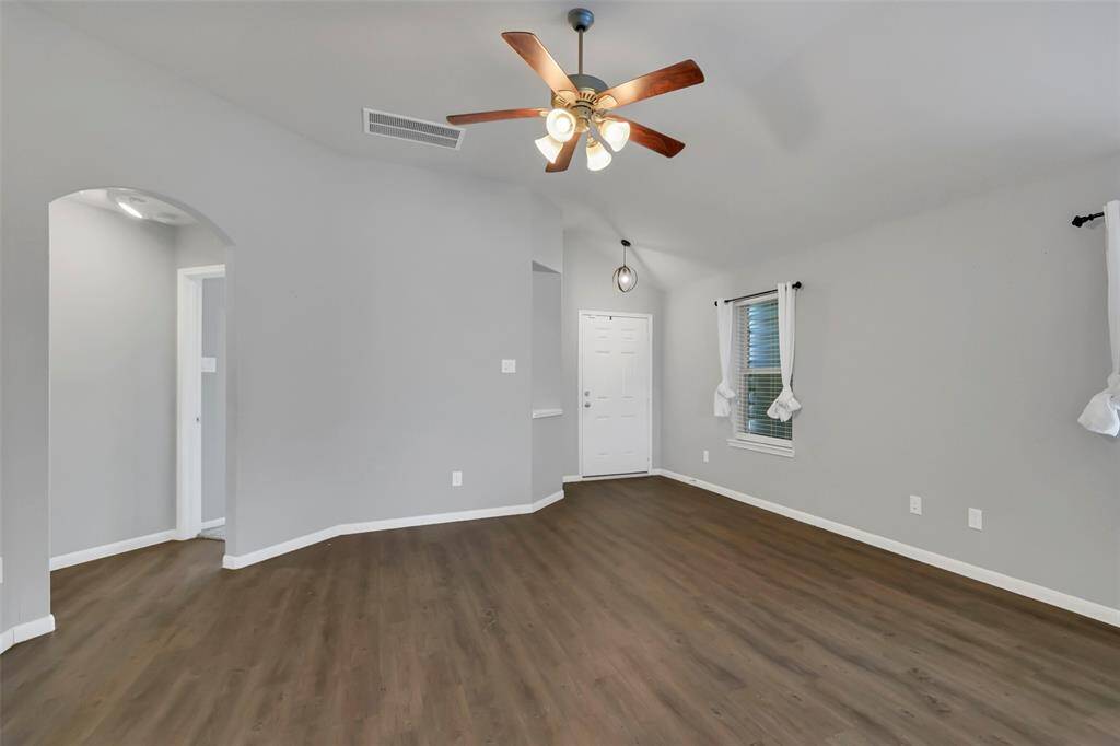 Access to the secondary bedrooms, hall bathroom, and garage is through the doorway to the Left.