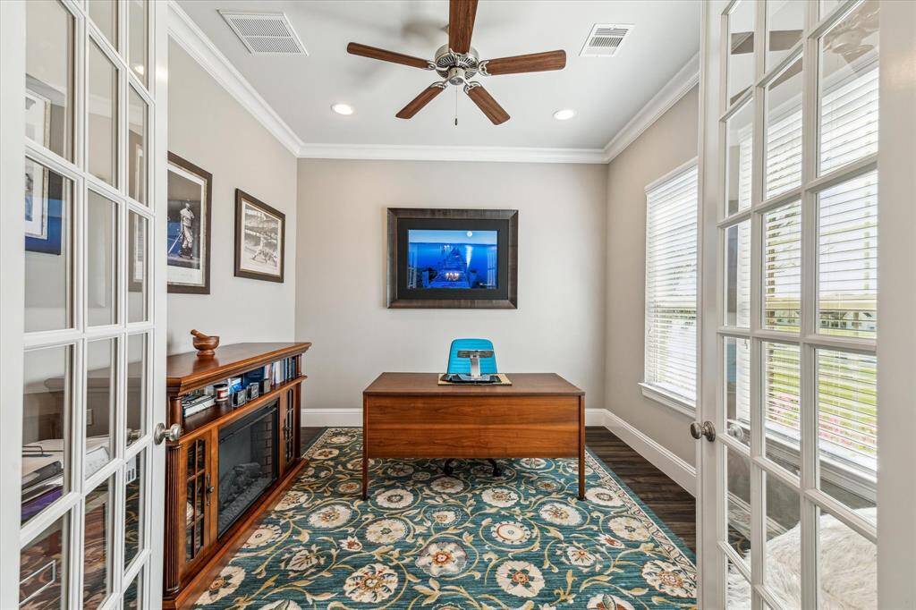 Located directly off the entry way with a view of the lake across the street.Glass French doors and crown molding.
