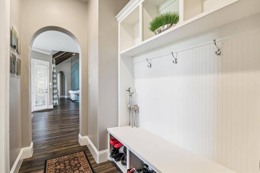 Large mudroom with bench, storage and closet.