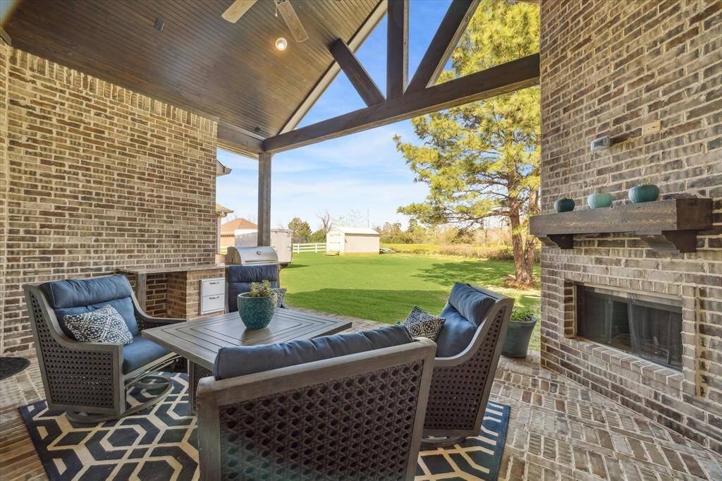 Outdoor gas fireplace/ floor to ceiling brick.