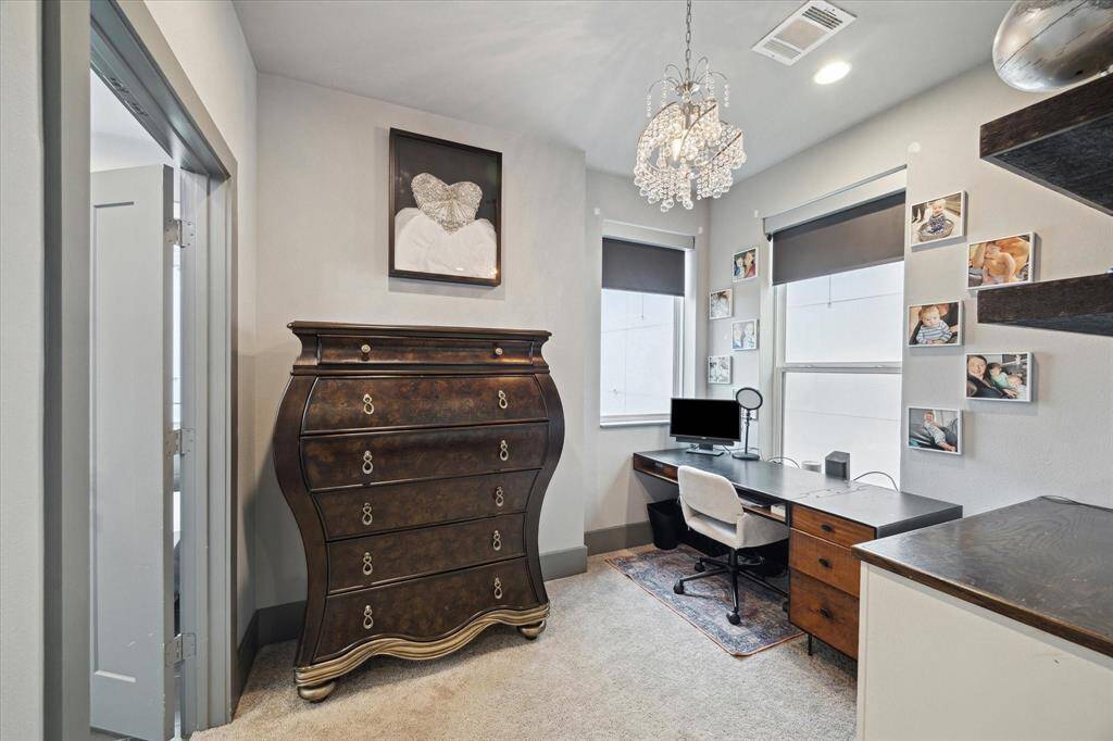 Comfy and stylish sitting area (currently used as an office) w/ built-ins and plenty of natural light.