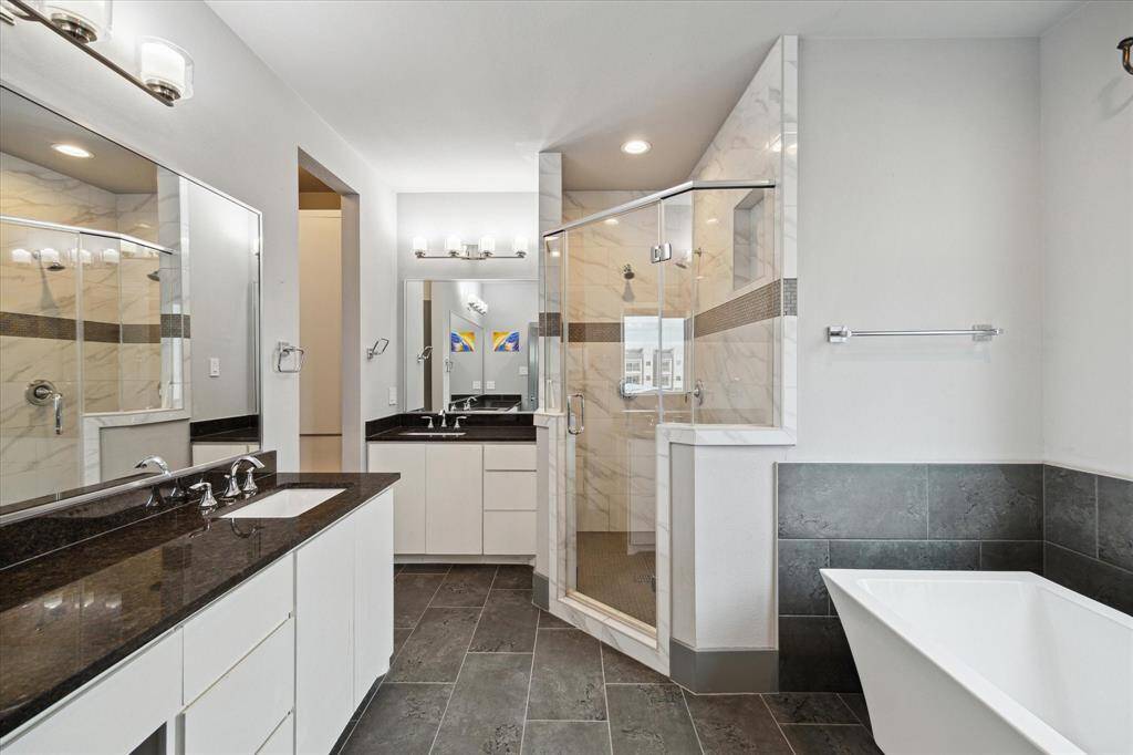 Unwind in your luxurious spa-inspired bath featuring a double vanity, walk-in shower, free standing tub and large walk-in closet.