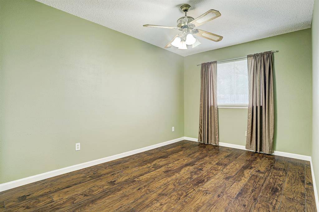 Bedroom - This bedroom has a large window, ceiling fan and laminate flooring for easy cleaning.