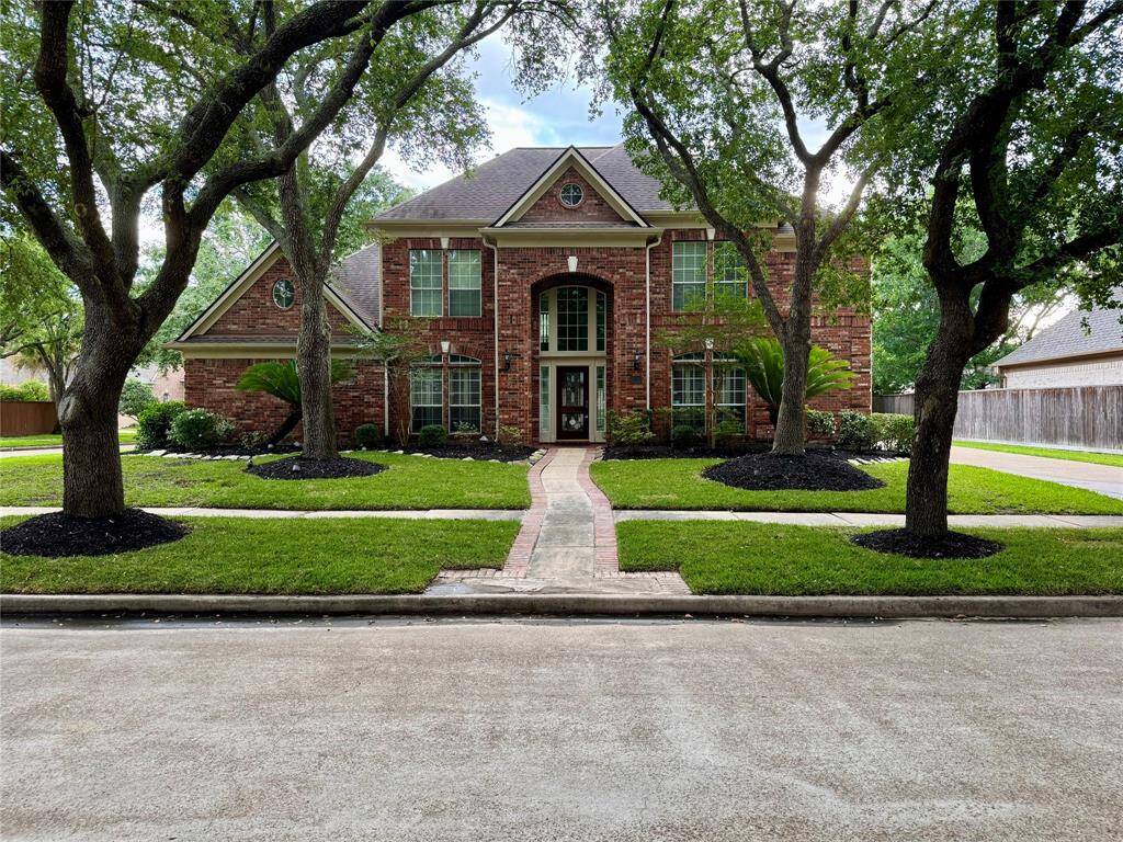 Outstanding curb appeal accentuated by mature, attractive trees.