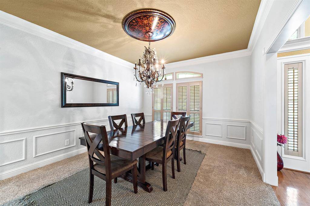 Decorative moldings surround the impressive dining room.