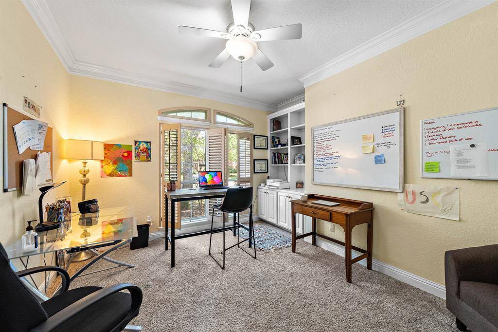 The private home office includes custom built-in bookshelves.