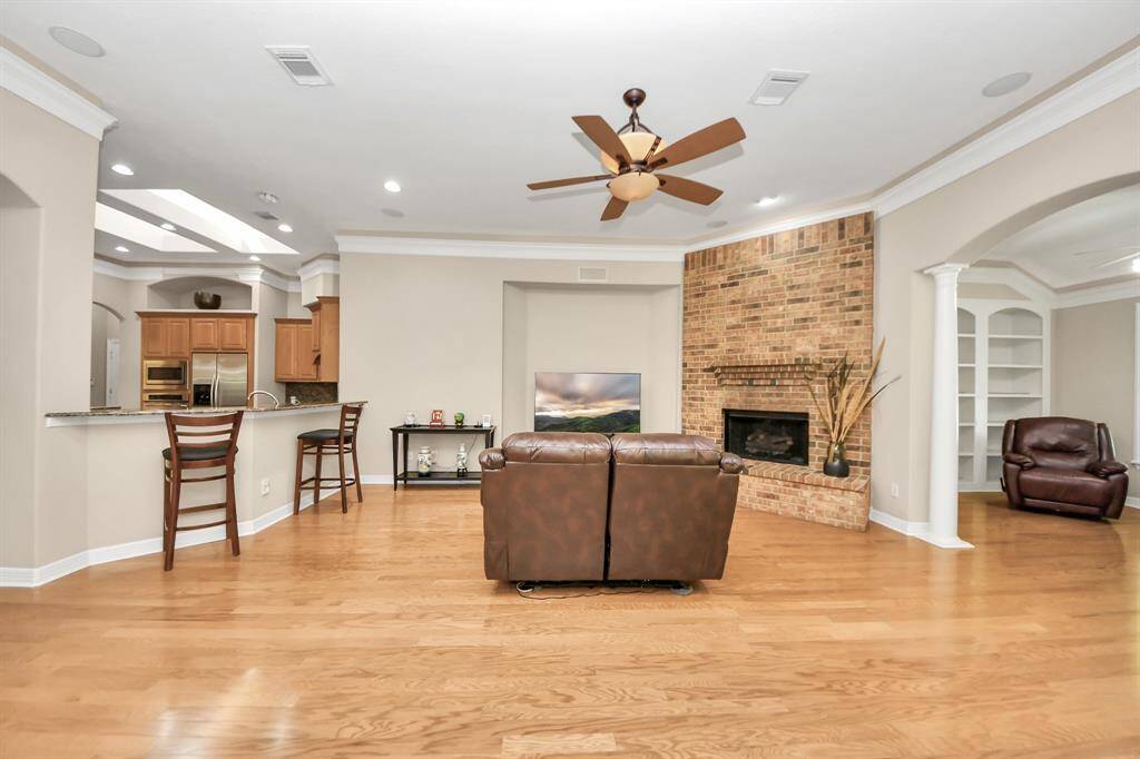 Surround sound speakers throughout the house with crown molding and accent lighting.