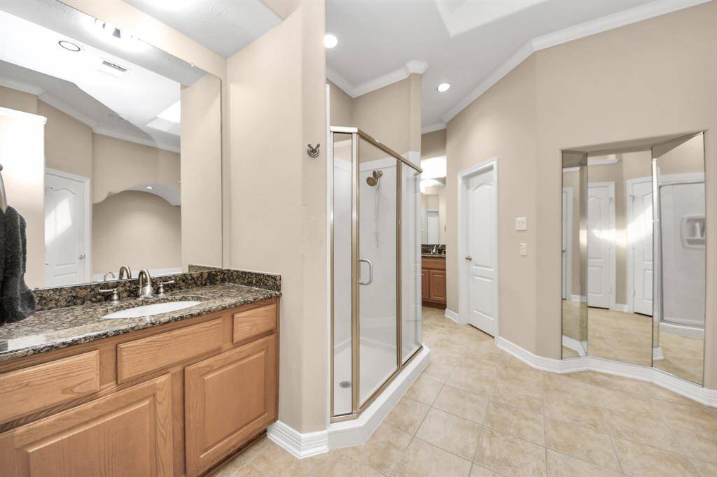 Primary Bathroom offers separate vanities, shower, and soaking tub.