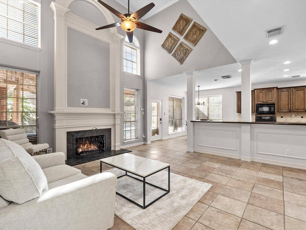 Let's move on to the family room and kitchen areas.  Gas log fireplace.  Lots of bright natural light.  Open concept from kitchen to family room.