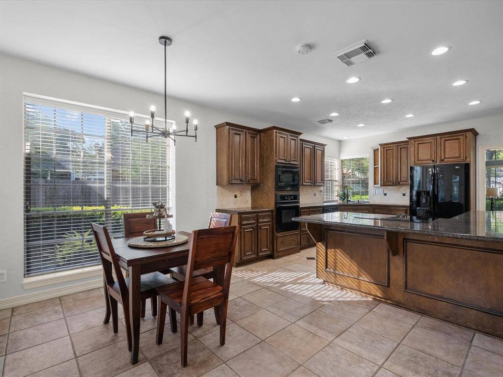 A view of the kitchen featuring the elegant cabinets and granite counters.