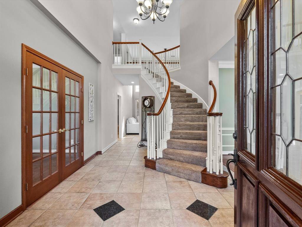 Welcome home.  The entryway is beautiful.  Featuring custom tile and French door on the office on your left.