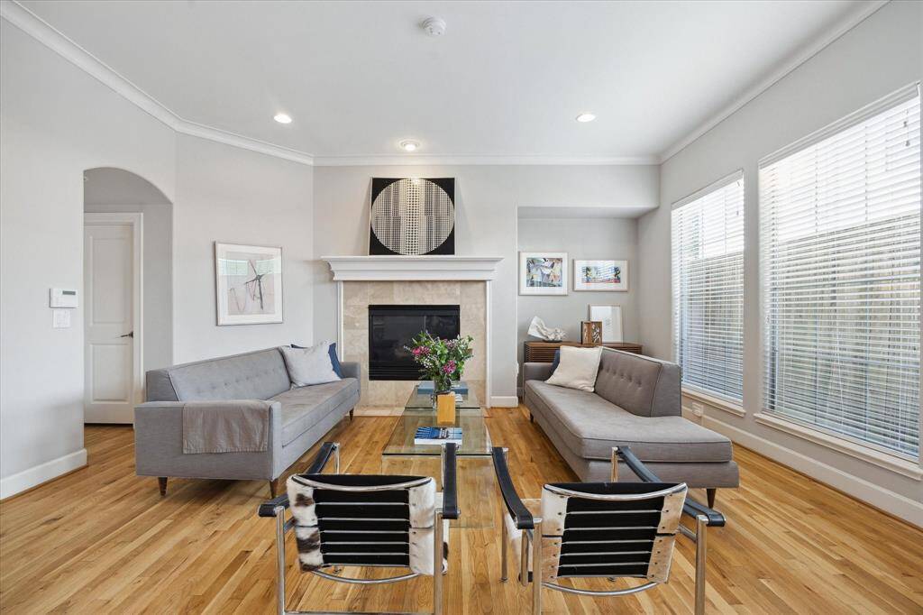 Lovely family room with entertainment nook and gaslog fireplace with classic white mantel