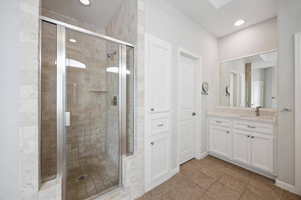 Primary bath also with separate shower and linen cabinets