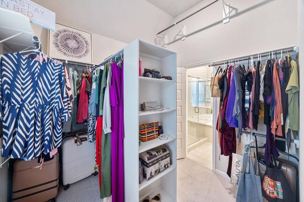 Spacious primary closet with shelves