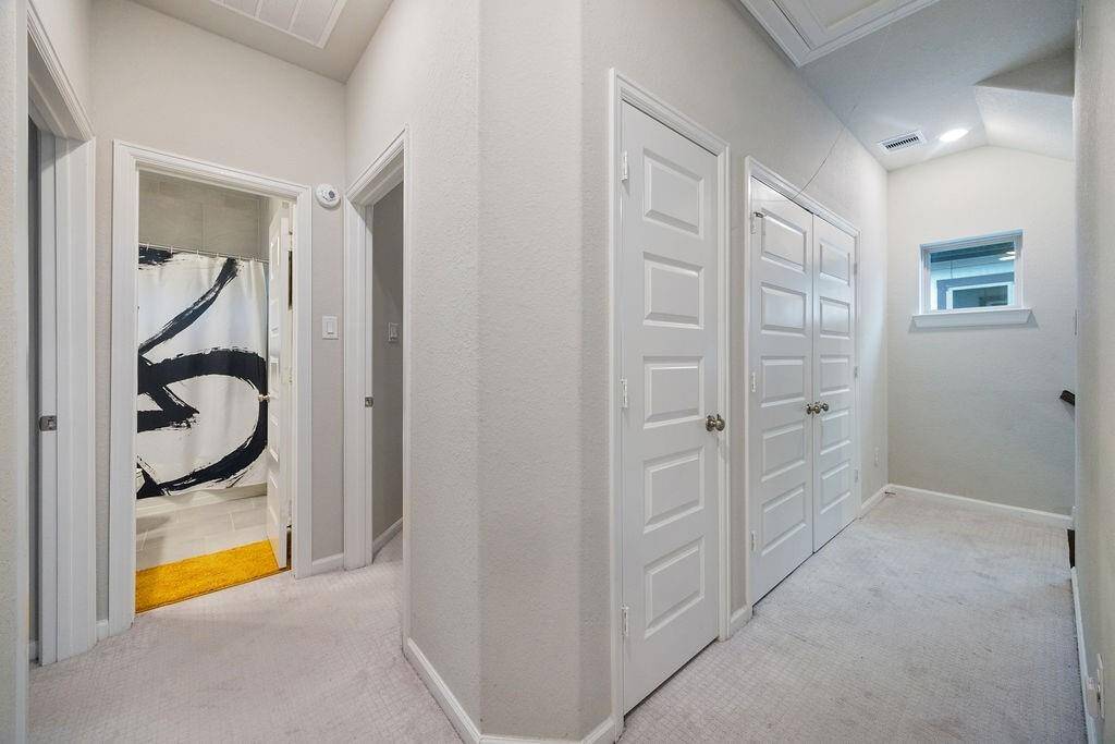 Hallway includes storage and laundry room