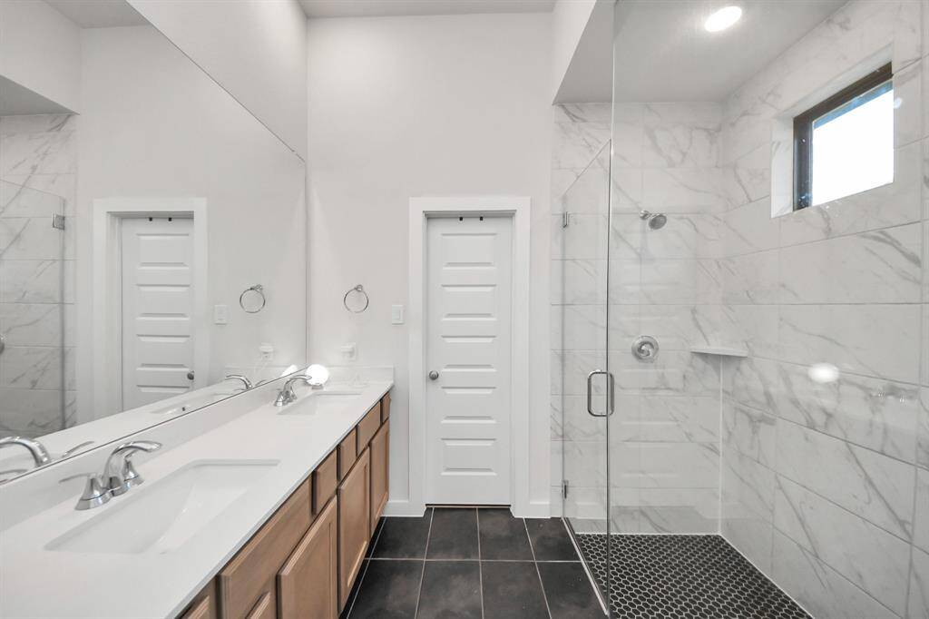 Luxurious Primary Bath with Large Shower and Dual Vanities.