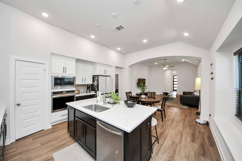 Beautiful Dark Blonde Floors with Black accents in kitchen.