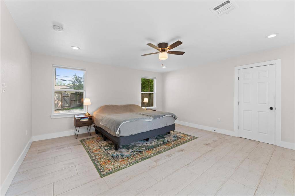 Spacious primary suite with barn door entry to walk-in closet and en-suite bath.
