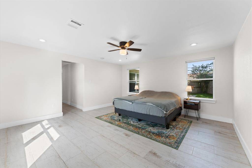 Spacious primary suite with barn door entry to walk-in closet and en-suite bath.