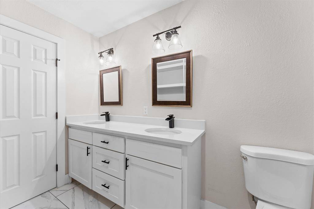 Beautifully updated bathroom with modern tile and sleek fixtures.