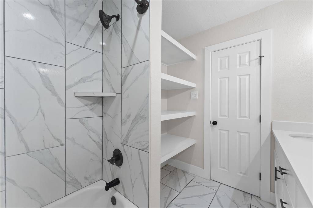 Beautifully updated bathroom with modern tile and sleek fixtures.