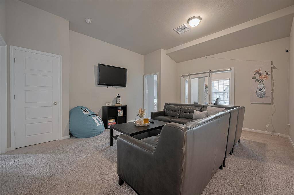 This cozy living space it’s located in the second floor. Natural light flows through large windows.