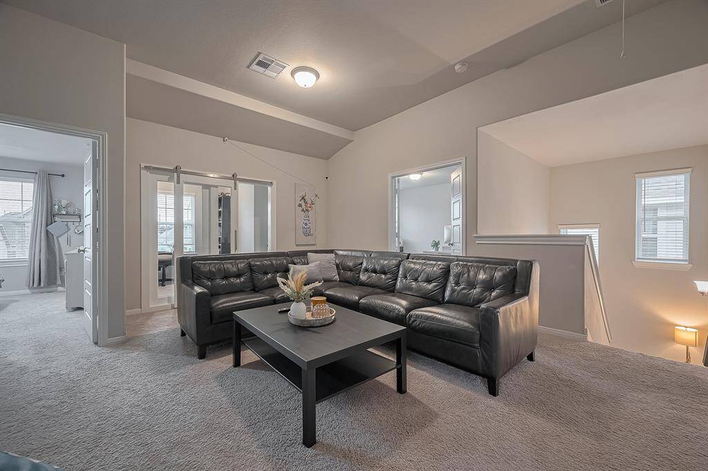 This cozy living area offers a warm and inviting atmosphere with easy access to adjacent rooms.