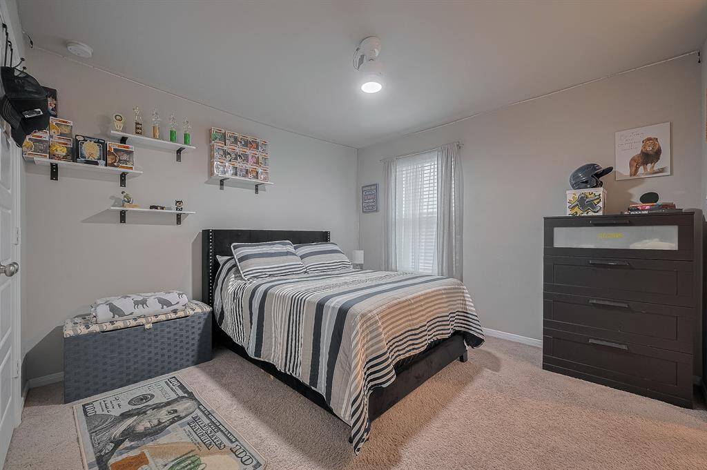Cozy and well-lit bedroom with neutral walls, perfect for a child or teenager.