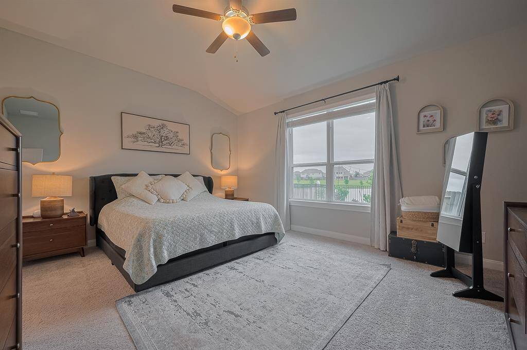 This spacious bedroom features a large window with a scenic view.