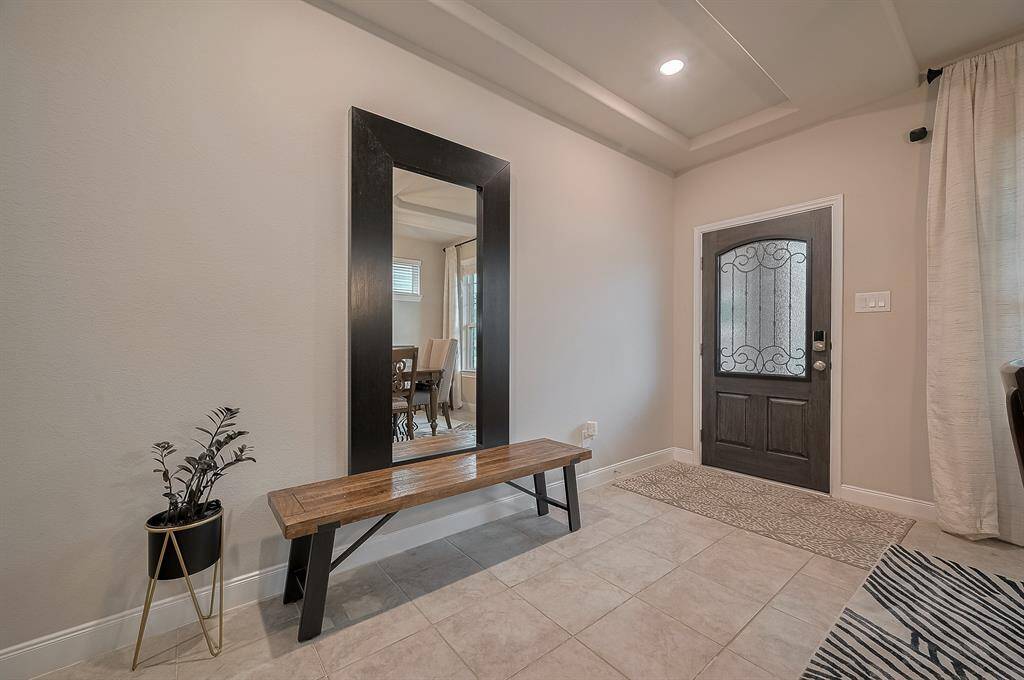 The space is accented by neutral tile flooring and soft wall colors, creating a welcoming ambiance.