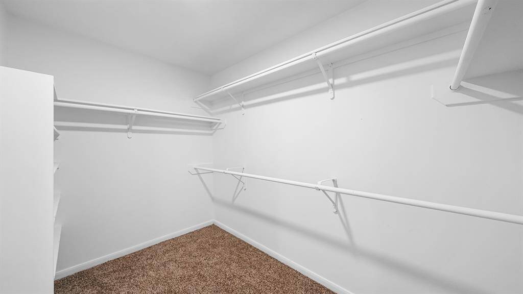 Large walk in closet has ample space for storage!