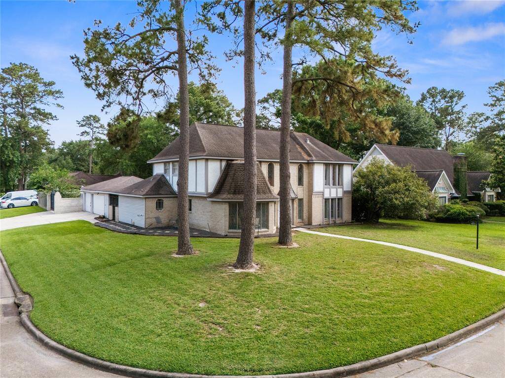 This home sits on an oversized corner lot surrounded by mature pines, featuring a side-entry garage, double wide driveway