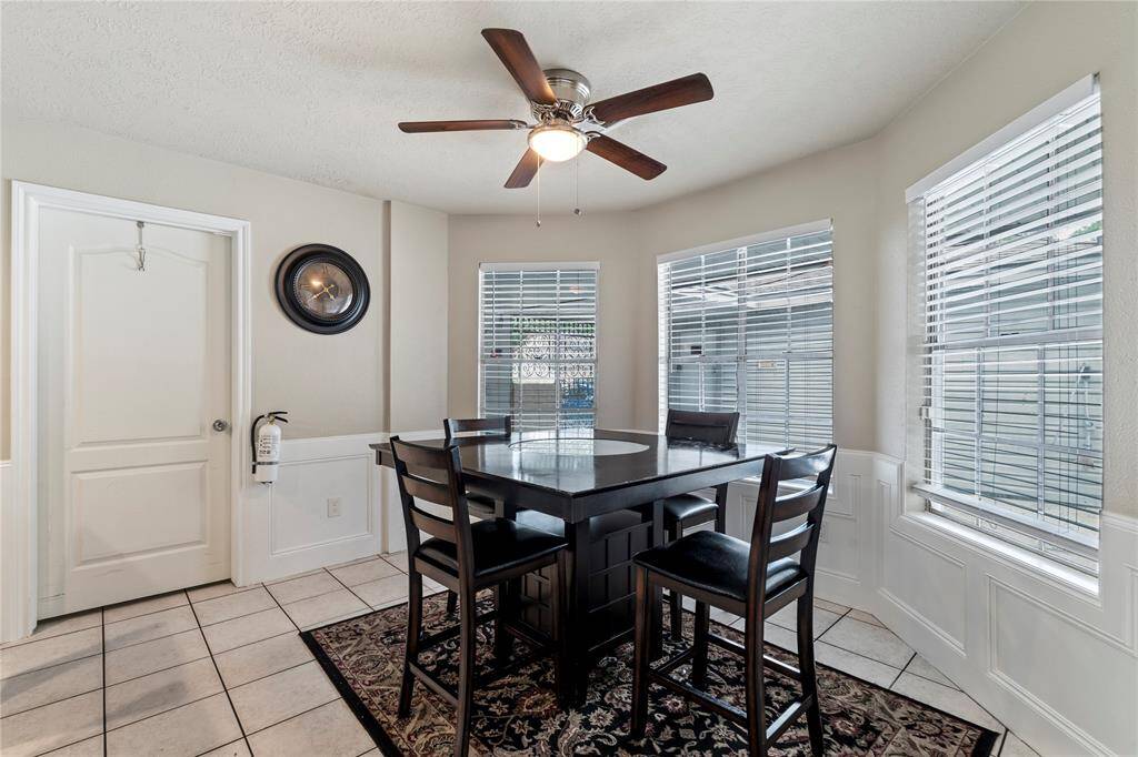 Bright and functional, this breakfast area sits just off the kitchen with wraparound windows that create an inviting spot for casual meals or morning coffee.