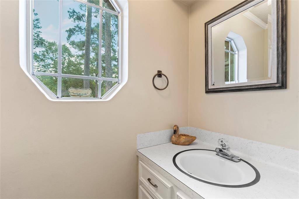 Bright and functional half bath located just off the utility room.