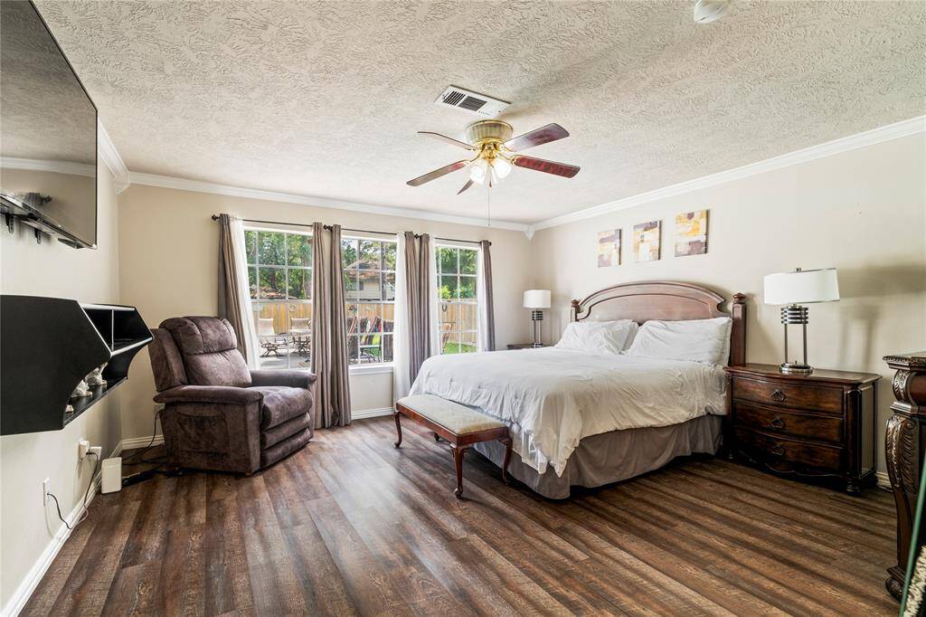 The spacious primary suite features backyard views of the pool, crown molding, offering a private retreat with plenty of natural light.