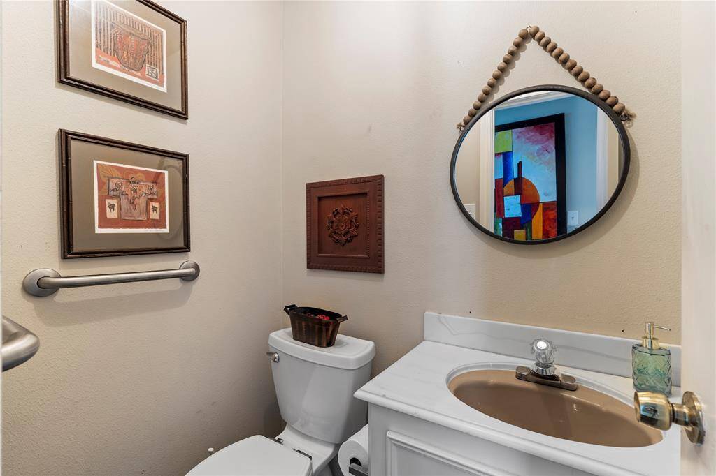 Secondary half bath with vintage charm—perfect for guests or added convenience near the main living areas.